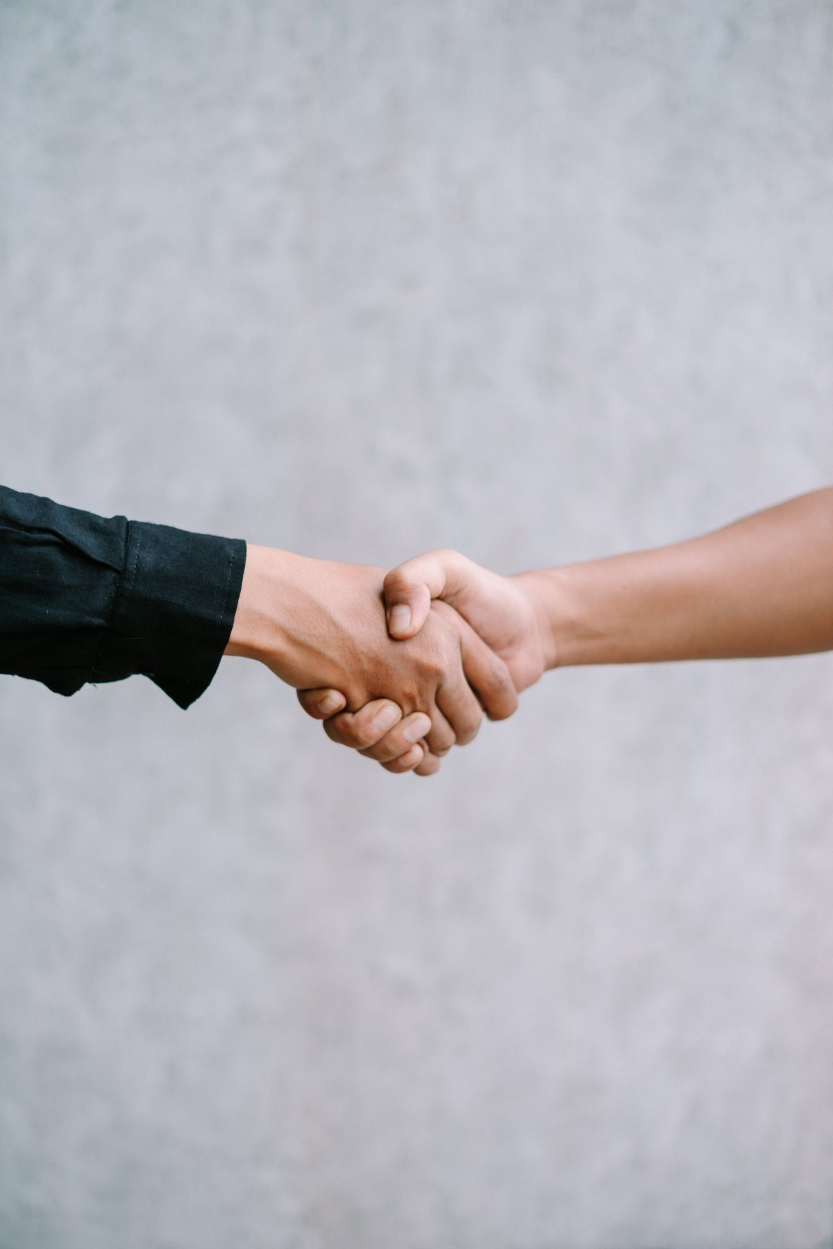 Two people shaking hands in agreement