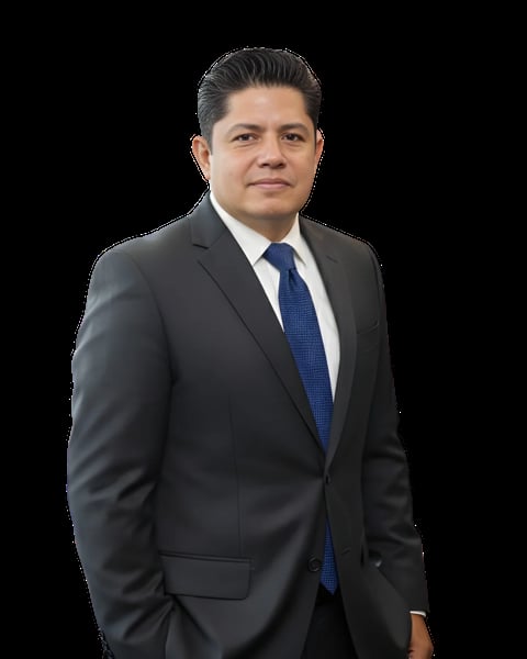 Professional headshot of a man in a dark gray suit with blue tie against a black background